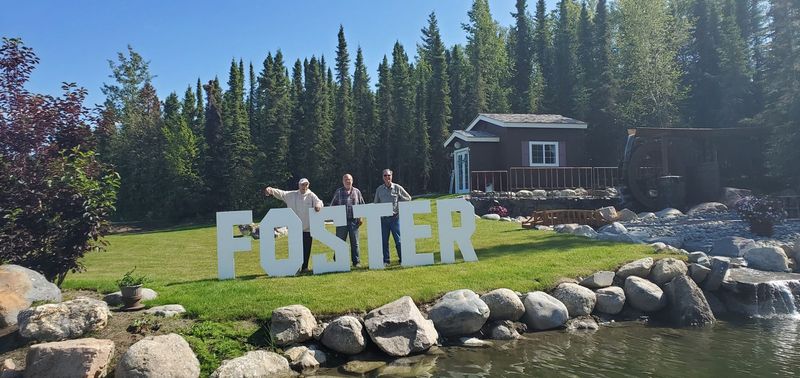 FOSTER letters spelled out on the lawn beside the pond