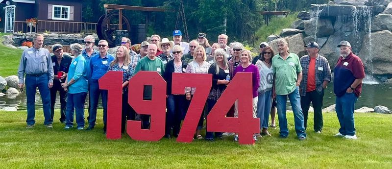 Class of 1974 reunion behind red 1974 letters