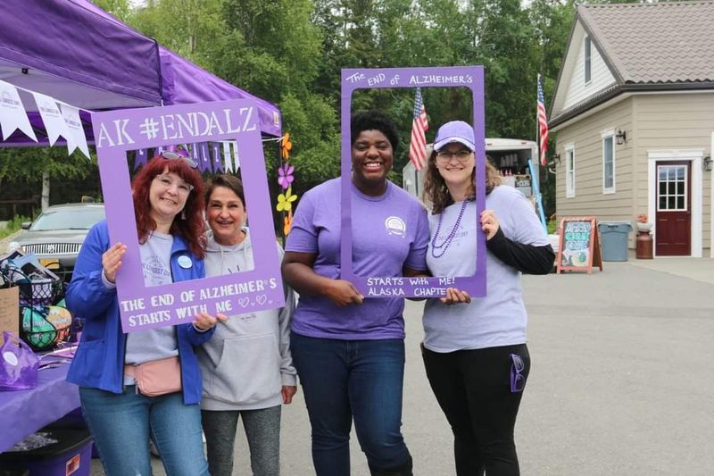 A group of volunteers with photo frames at a Walk to End Alzheimer's event