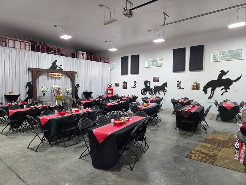 The indoor event hall set for a western-themed dinner