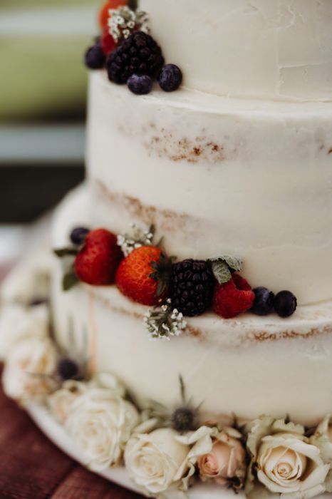 A wedding cake topped with fresh berries